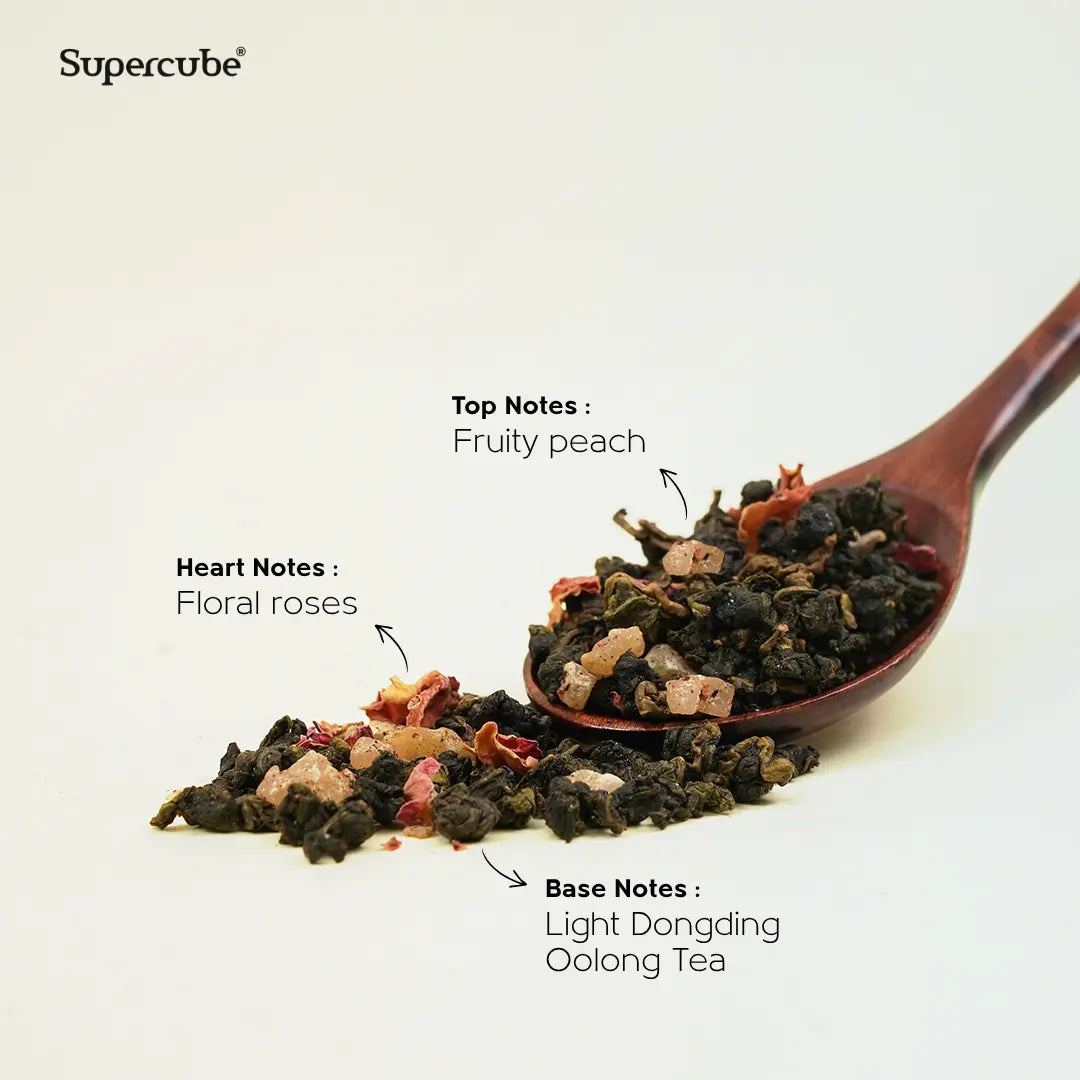 Supercube Sweet Peach Oolong loose leaves on a wooden spoon showing peach, rose and Dongding oolong tasting notes